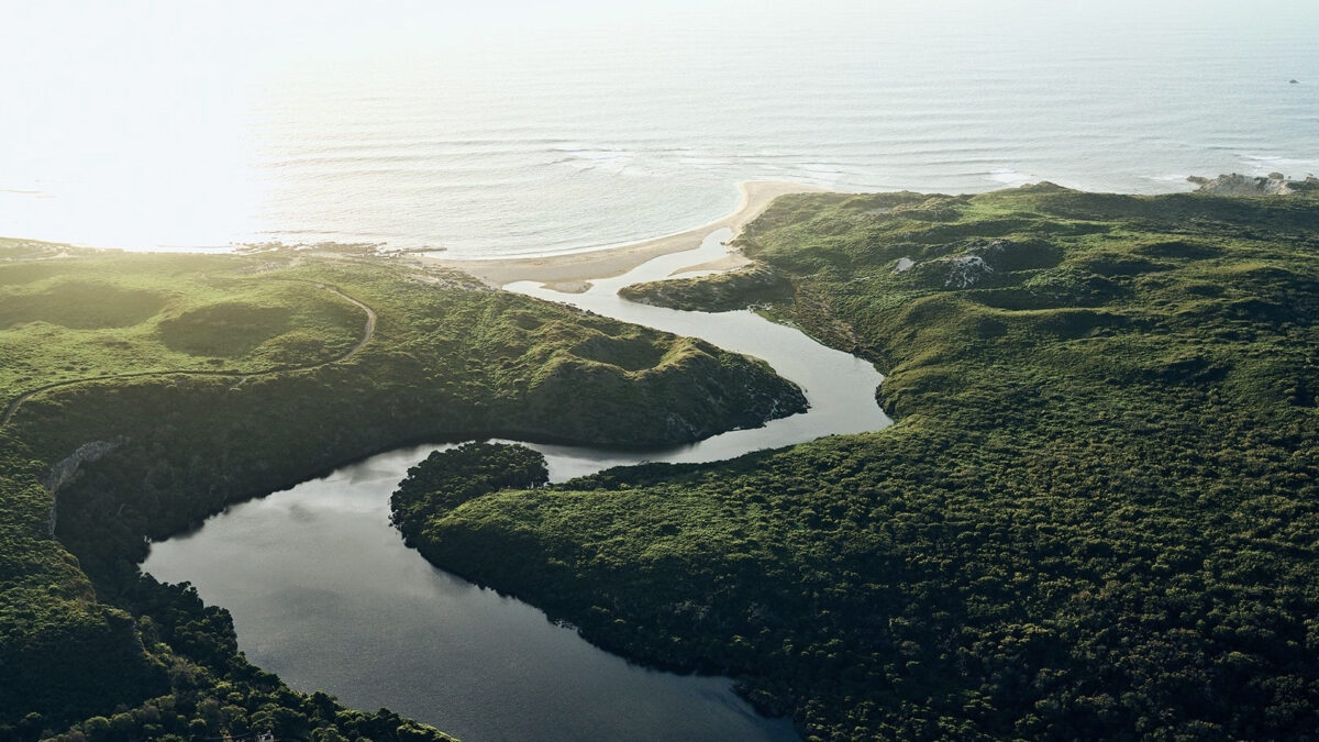 River leadong out to the pacific ocean in spring with verdant rolling hills