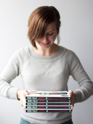 Madeline Puckette, Wine Folly's co-founder holds some books