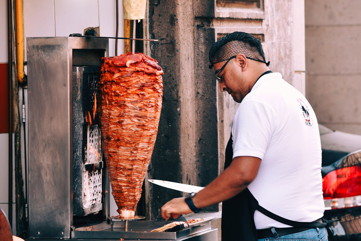 A man working a gyro machine. 