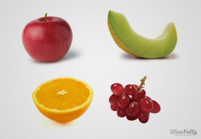 orange apple grape and a melon on a white background